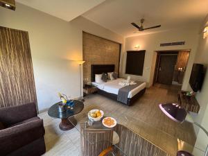 a hotel room with a bed and a table at RESIDENCY HOTEl in Jāmb