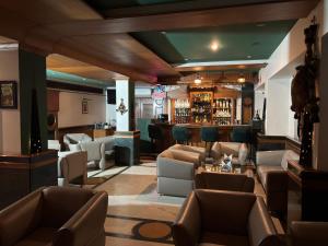 a lobby with couches and a bar at RESIDENCY HOTEl in Jāmb
