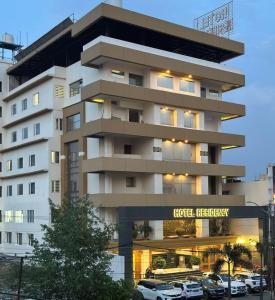 a hotel with cars parked in front of it at RESIDENCY HOTEl in Jāmb