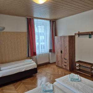 a room with two beds and a large window at Familie Zuser Hotel Garni in Mitterbach +73 photos