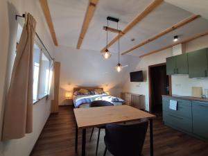 a bedroom with a bed and a table in a room at Apartmány pod Štěpánkou in Kořenov +59 photos