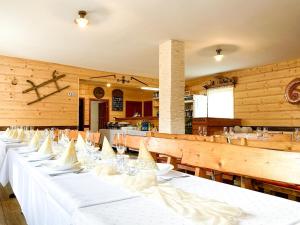 a row of white tables in a restaurant at Penzión u Komu Žaškov, okres Dolný Kubín in Žaškov
