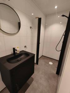 a bathroom with a black sink and a mirror at Gjøa Motell in Rosendal +48 photos