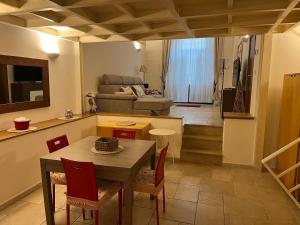 a living room with a table and chairs and a couch at Casa Mola di Bari in Mola di Bari +11 photos