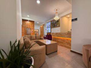 a living room with a couch and a table at Norbu Healing Hotel in Thimphu