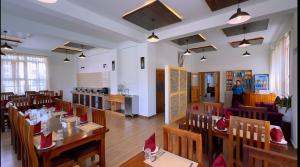 a restaurant with tables and chairs with red hats on them at Norbu Healing Hotel in Thimphu