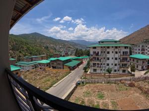 a view from a balcony of a city with buildings at Norbu Healing Hotel in Thimphu