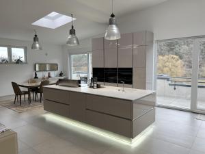 a kitchen with a large island and a dining room at LOFT - Exclusive Penthousewohnung in Könen