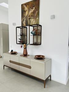 a white dresser with a mirror on top of it at LOFT - Exclusive Penthousewohnung in Könen