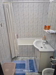 a bathroom with a white tub and a sink at ARTIFICII București in Bucharest