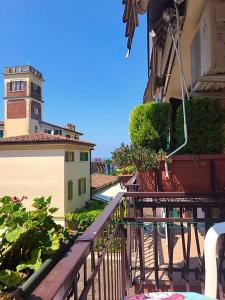 a balcony of a building with a lighthouse in the background at Casa Sponchie in Lazise