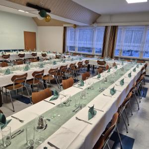 a large conference room with long tables and chairs at Familie Zuser Hotel Garni in Mitterbach