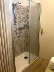 a shower with a glass door in a bathroom at Casa Sponchie in Lazise