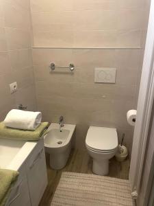 a bathroom with a white toilet and a sink at Casa Sponchie in Lazise