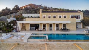 a house with a swimming pool in front of it at Jerina Mansion by PikHost in Tirana
