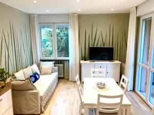 a living room with a couch and a table at Modern 90sqm Apt - Ideal Base for Parma & Modena in Cavriago