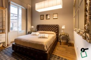 a bedroom with a bed and a large window at Hotiday Cagliari Porto in Cagliari