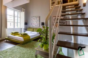 a living room with a staircase and a couch at Hotiday Cagliari Porto in Cagliari