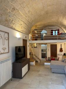 a living room with a couch and a tv at Casa Mola di Bari in Mola di Bari