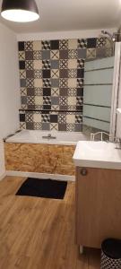 a bathroom with a sink and a mirror at Sous les toits de Béthune in Béthune