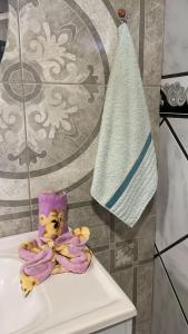 a stuffed animal sitting on a sink in a bathroom at Pousada Nunes in Lauro Müller