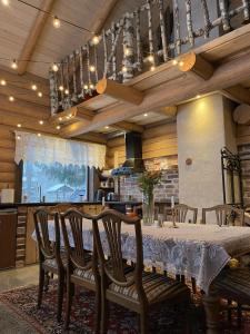 a dining room with a table and some chairs at Nordic Log-House with Sauna in Valga