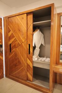 a wooden closet with a wooden door at Namaste Corbett Resort and Spa in Jāmb +95 photos