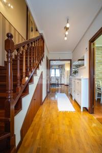 a hallway with a staircase in a house at La Casina Azul de May By Silastur in San Juan de la Arena