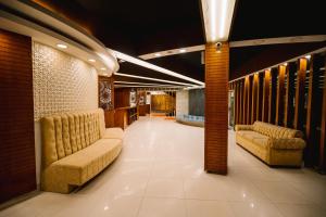 a lobby with couches and chairs in a building at Royal Hotel Khulna - City Center in Khulna
