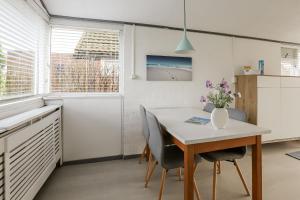 a kitchen with a table and chairs in a kitchen at Rekerlanden 90 in Schoorldam