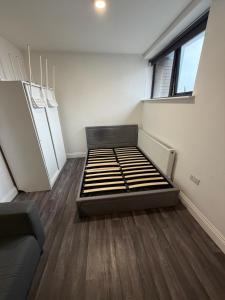 a room with a bed in the middle of a room at Kensway House in Ilford
