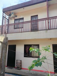 an apartment building with a balcony and a ladder at Eve's Place Transient Apartment in Tanay