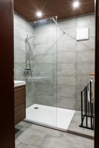 a bathroom with a shower with a glass door at Haus Waldruhe in Mallnitz +47 photos