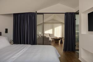 a bedroom with a bed and a couch at The Lake Loft in Ioannina