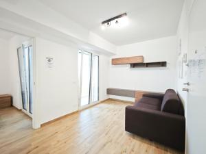 a living room with a couch and some windows at Gentilè in Bari