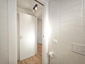 a bathroom with white walls and a white door at Gentilè in Bari +31 photos