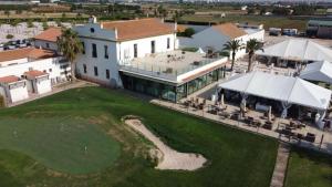an aerial view of a house with a golf course at Cosy Flat Catarroja in Catarroja