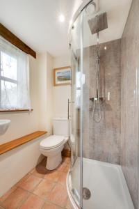 a bathroom with a toilet and a shower and a sink at 3 Bed in South Molton oc-millba in Bishops Nympton +18 photos
