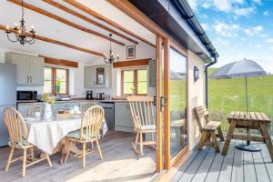 a kitchen and dining room with a table and chairs at 3 Bed in Bish Mill oc-e30946 in Bishops Nympton