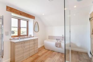 a bathroom with a tub and a sink at 3 Bed in Bish Mill oc-e30946 in Bishops Nympton +32 photos