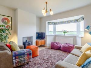 a living room with a couch and a tv at 3 Bed in Kings Lynn oc-82358 in Harpley