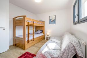 a bedroom with a bunk bed and a bed and a bed at Le Clos Carnonen, villa avec piscine in Quessoy +12 photos