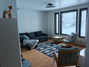 a living room with a couch and a table at Aurora riverside home in Rovaniemi