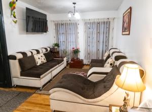 a living room with two couches and a lamp at Apartamento 32 Juana de Arco in Quito