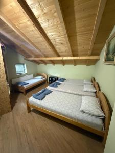 a bedroom with a bed and a wooden ceiling at Villa 80 Kodra e Diellit in Tetovo
