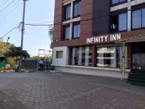 a man standing in front of a building at Infinity inn in Guna