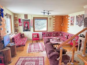 a living room with red couches and red chairs at Villa 80 Kodra e Diellit in Tetovo