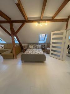 a bedroom with a bed in a room with wooden ceilings at Gemütliche Wohnung in Burg in Burg bei Magdeburg