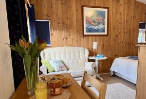 a living room with a white couch and a table at Meads Cabin in Charmouth