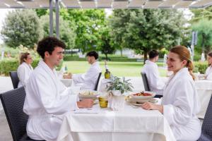 a group of people sitting at a table with food at Hotel Fontana Olente in Ferentino